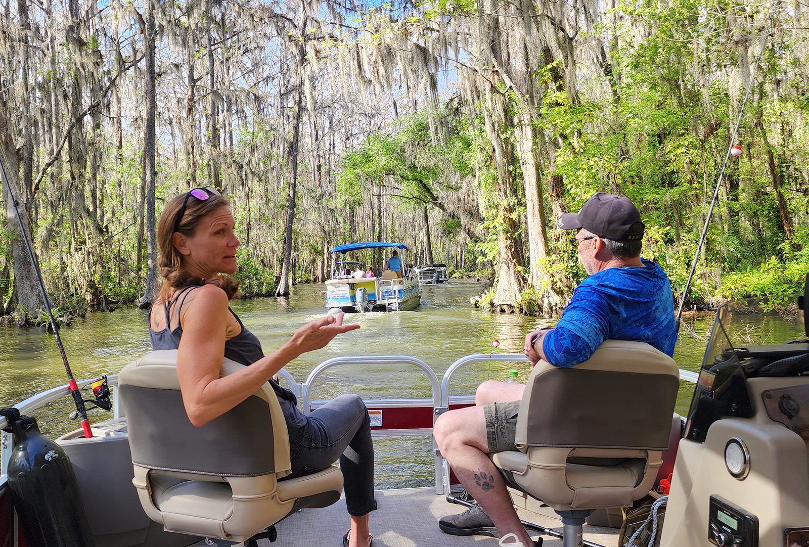A woman and a man talking aboard a pontoon boat