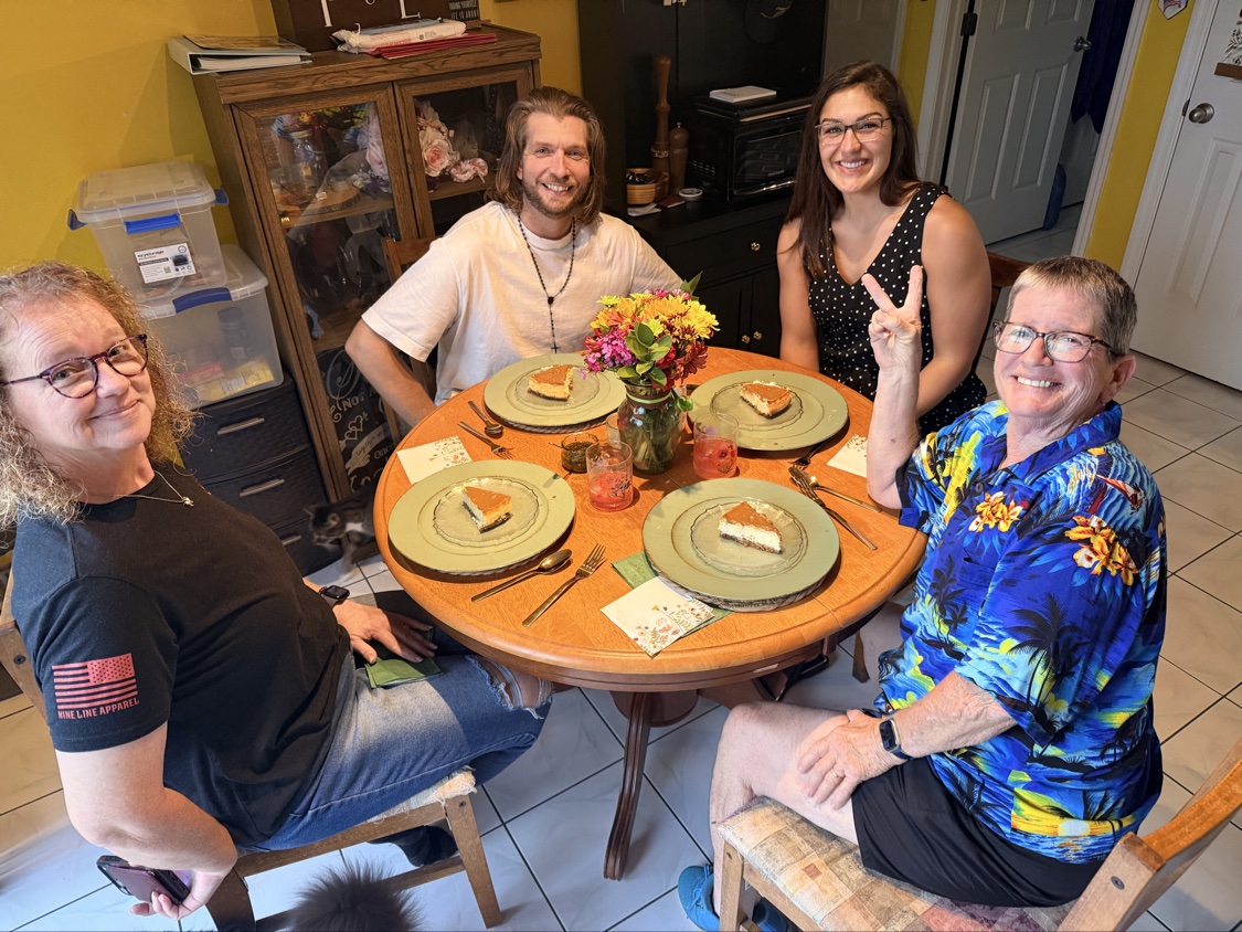 Everyone enjoying pie for dessert together