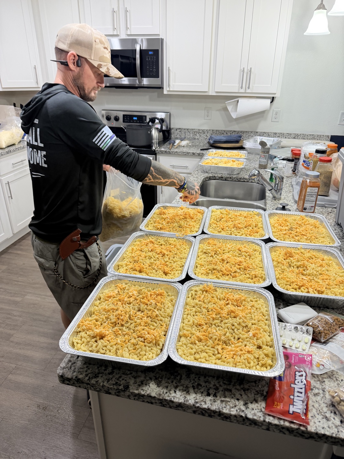 Prepping trays of mac and cheese for a community meal