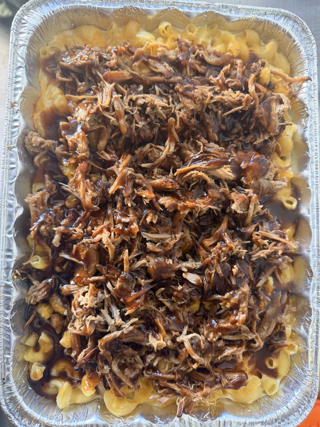 Pulled pork piled over mac and cheese