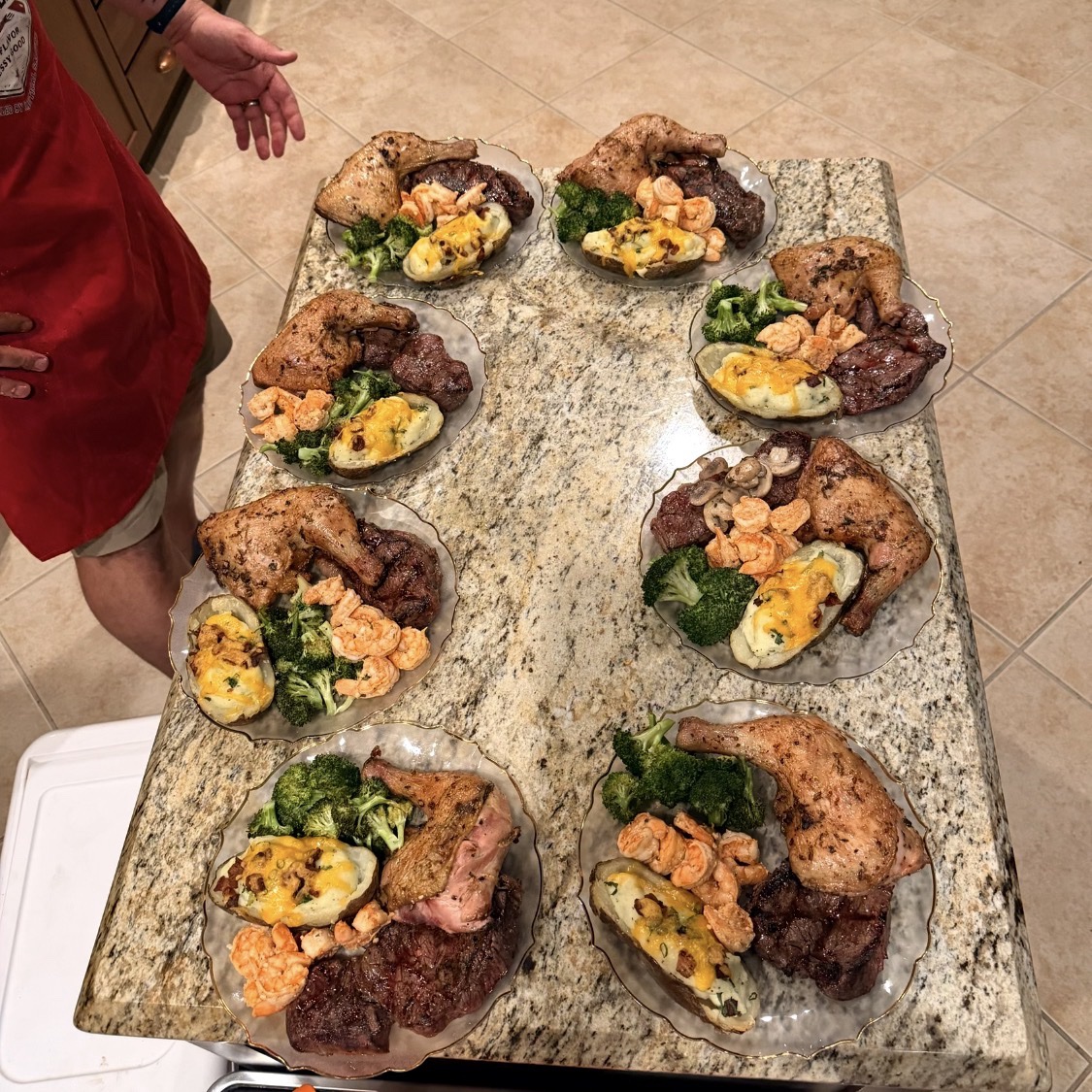 Plated surf-and-turf dinners with chicken, steak, shrimp, broccoli, and loaded potatoes